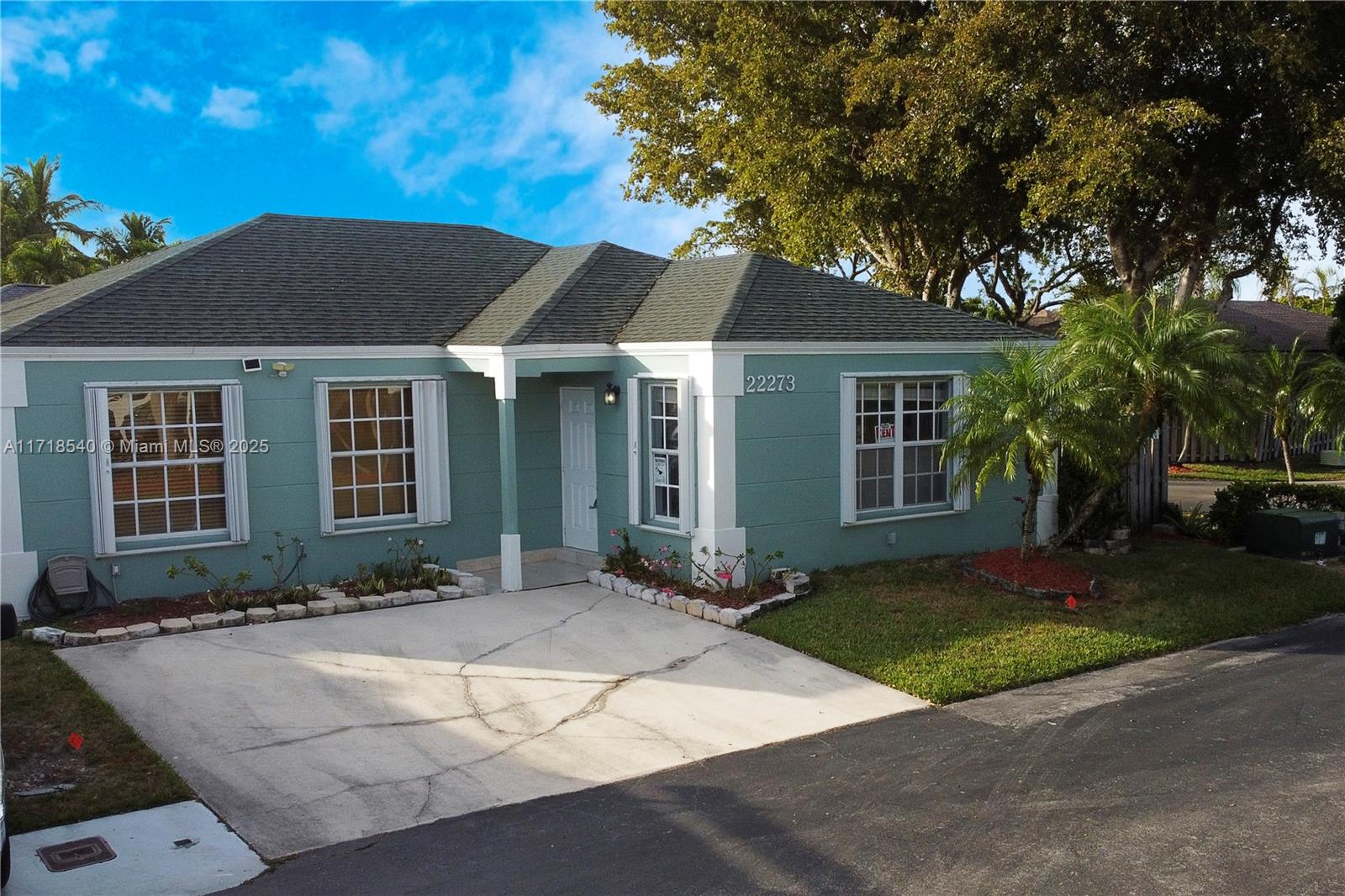 a front view of a house with a yard and a garage