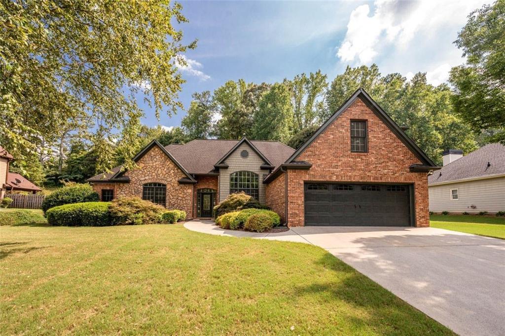 a front view of a house with a yard garage and outdoor seating