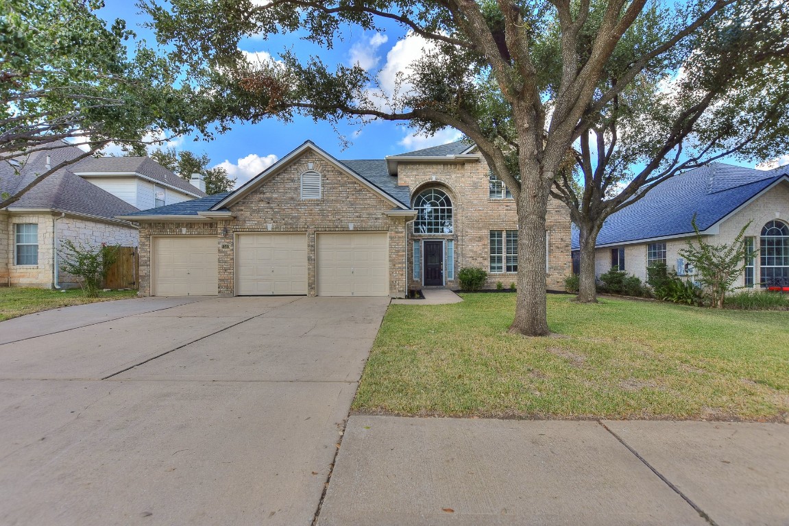 a front view of a house with a yard and garage