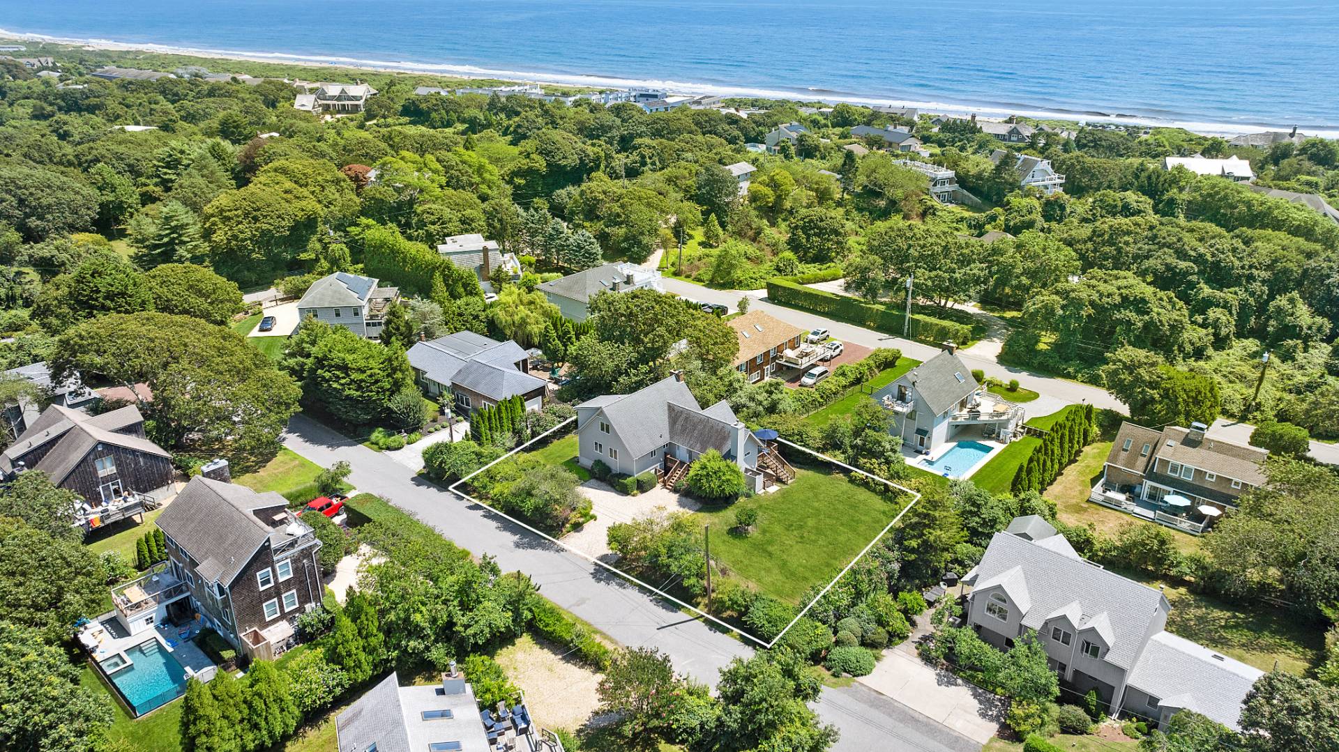 an aerial view of residential houses with outdoor space