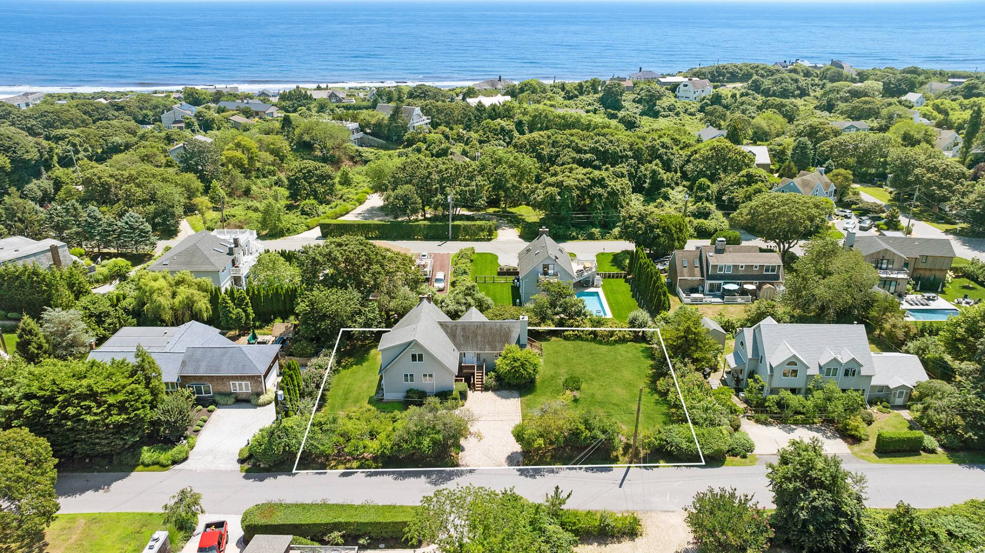 an aerial view of a house with a yard and lake view