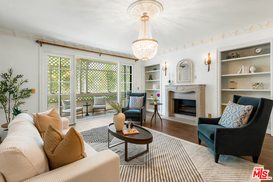 a living room with furniture a large window and a fireplace