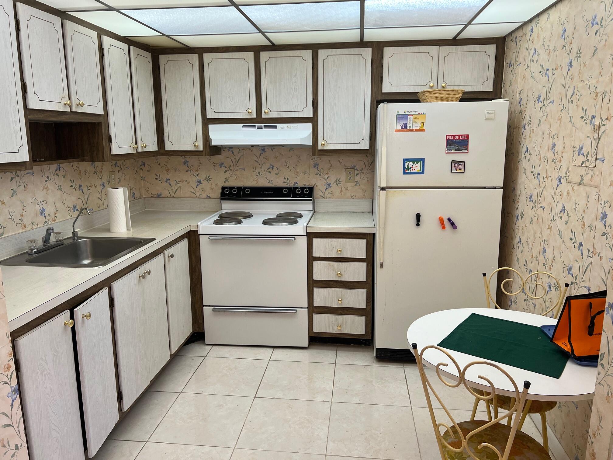 a kitchen with stainless steel appliances a refrigerator and a stove top oven