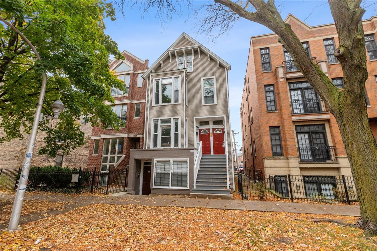 a front view of a house with a tree