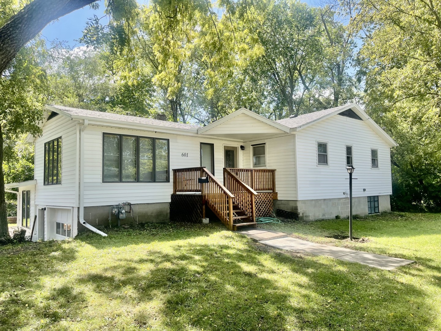 a view of a house with a yard and deck