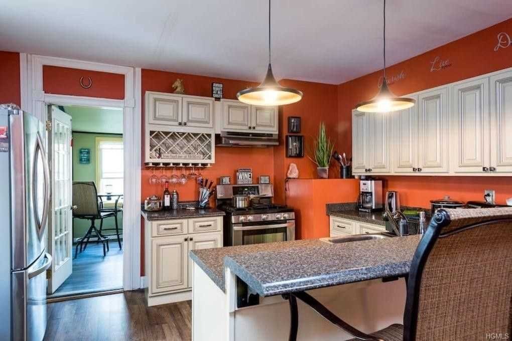 a kitchen with stainless steel appliances granite countertop a stove a sink and a refrigerator