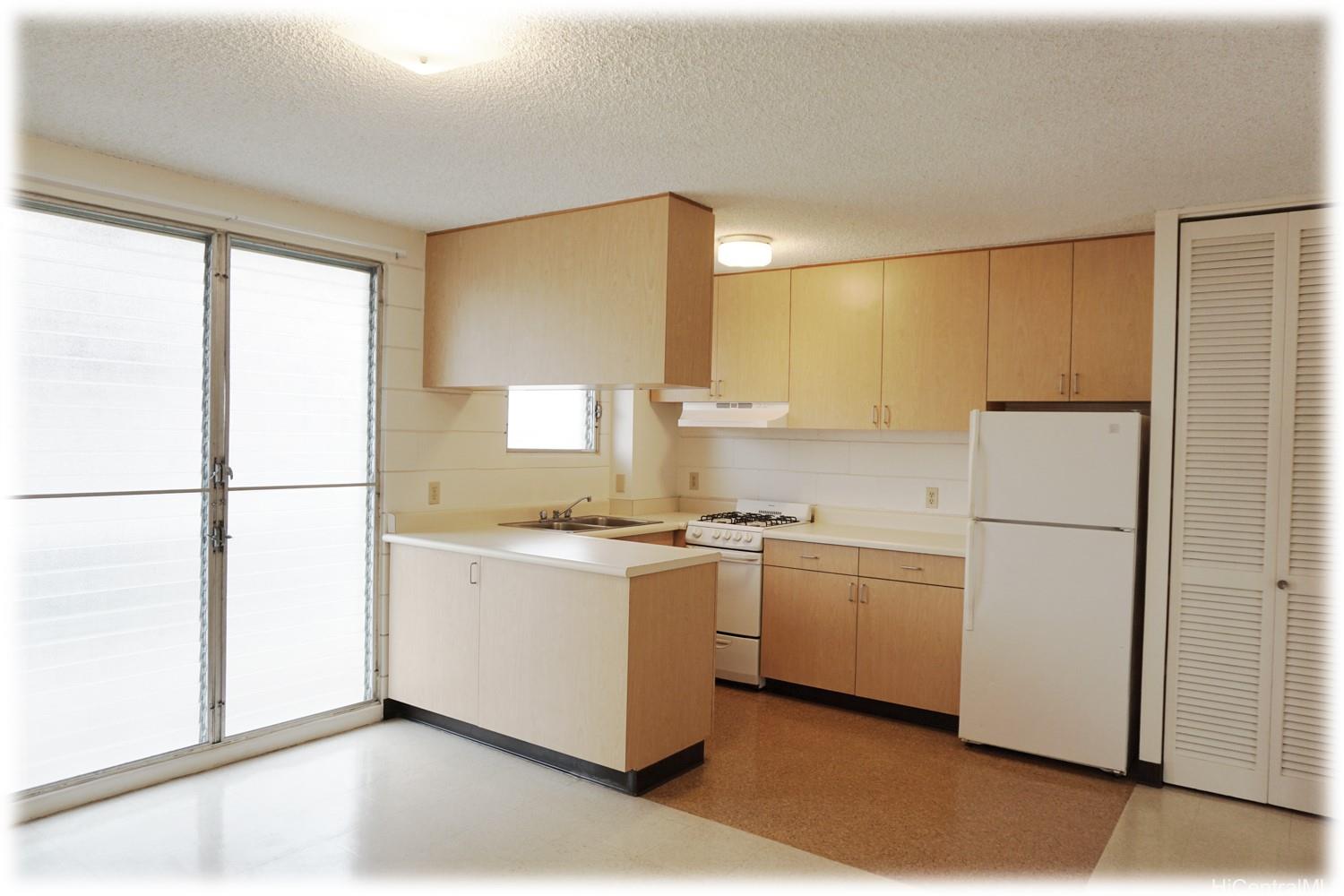 a kitchen with appliances a sink and a window