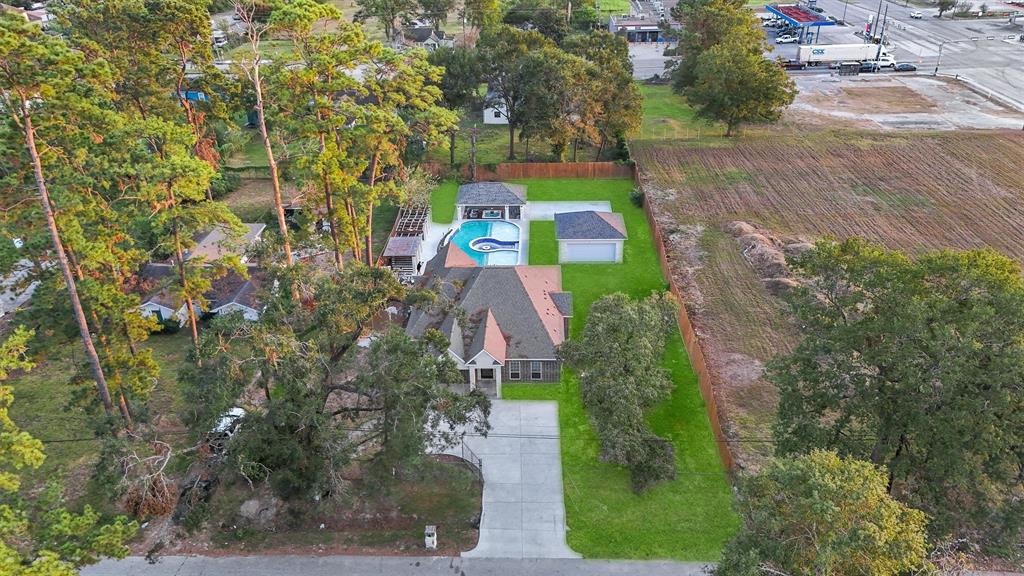 an aerial view of a house with a yard and trees