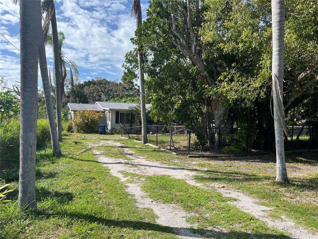 a view of a house with backyard and tree