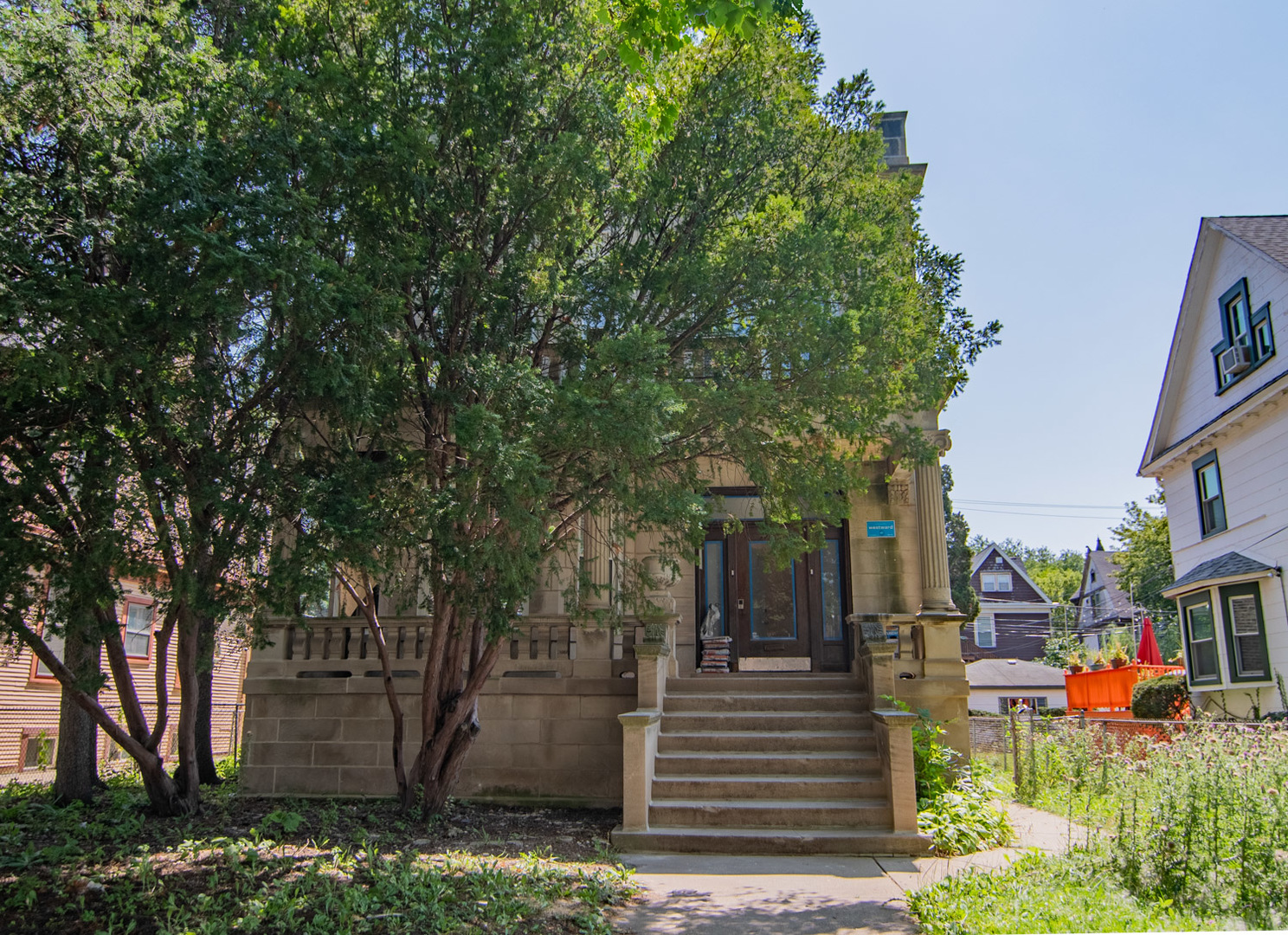 a front view of a house with a tree