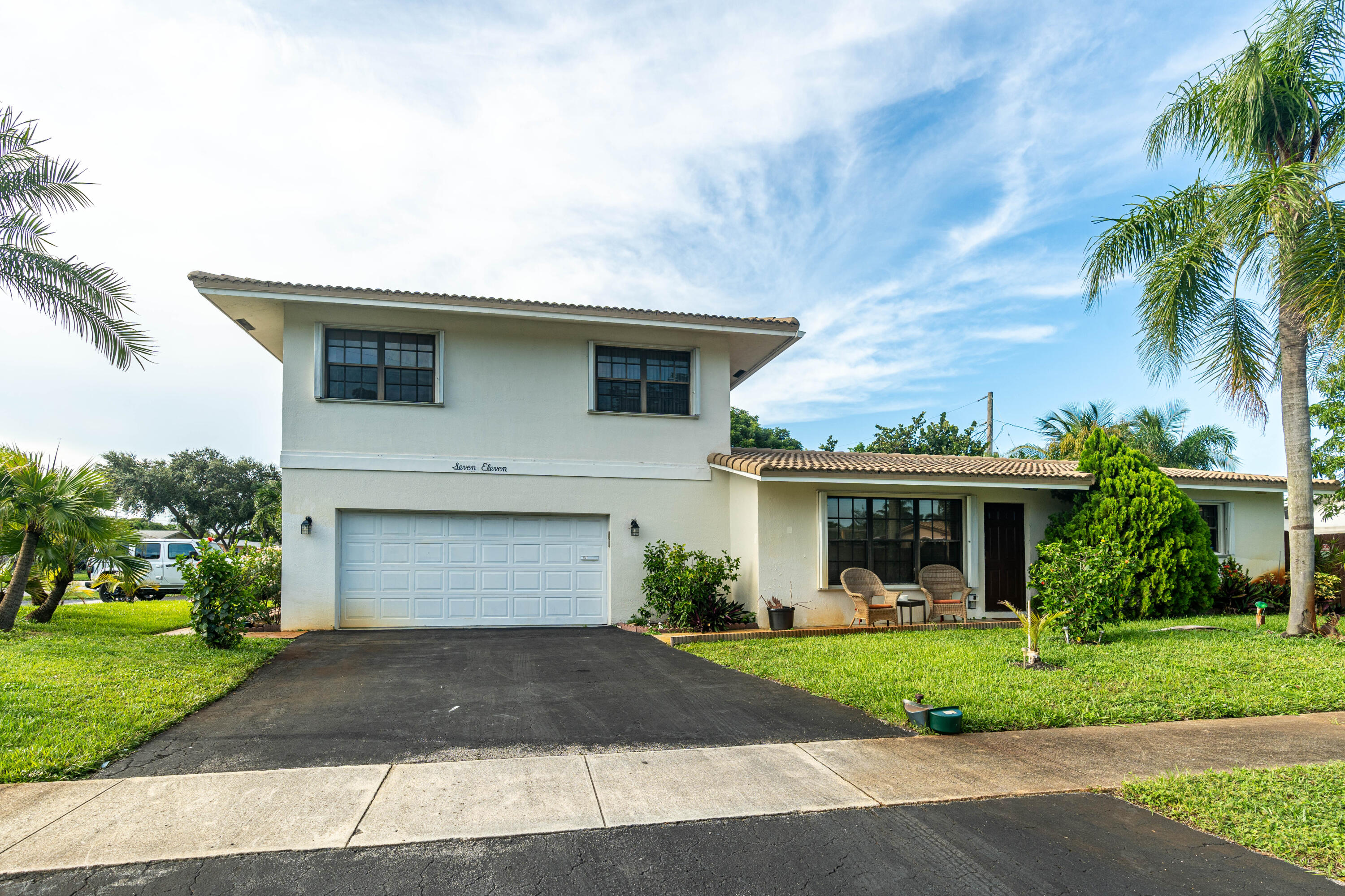 a front view of a house with a yard and garage