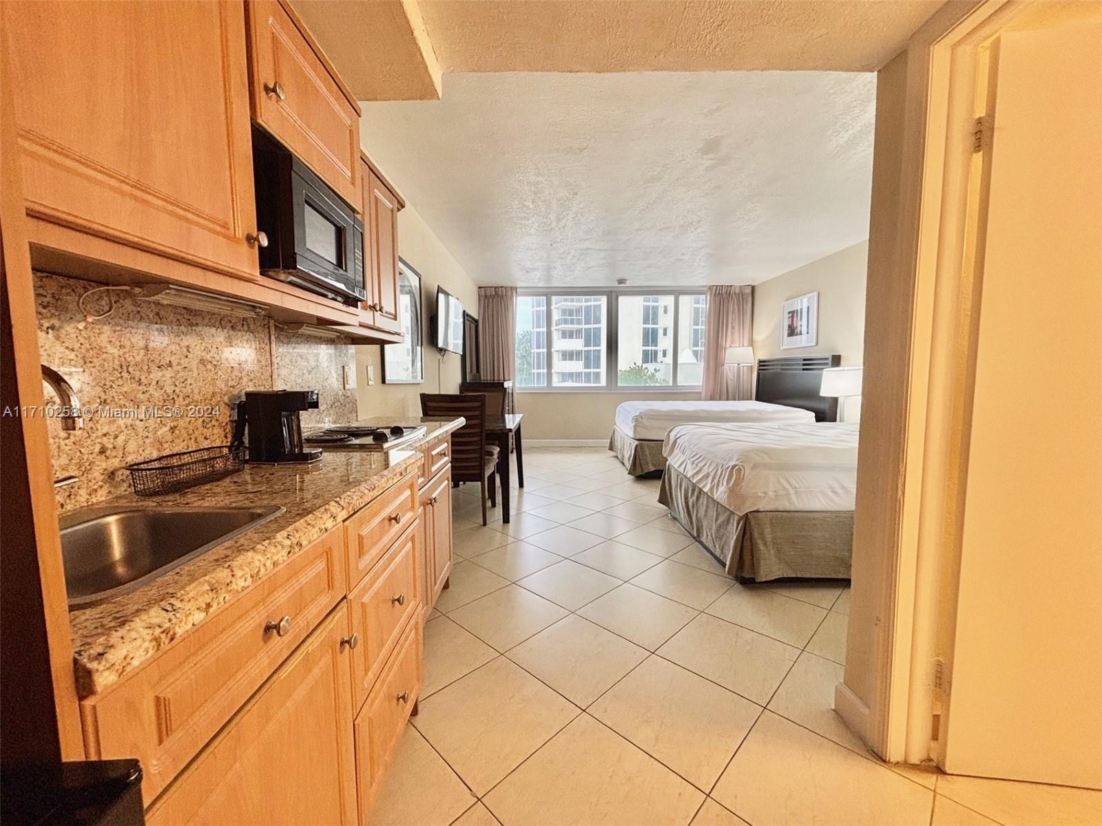 a kitchen with stainless steel appliances granite countertop a sink and cabinets