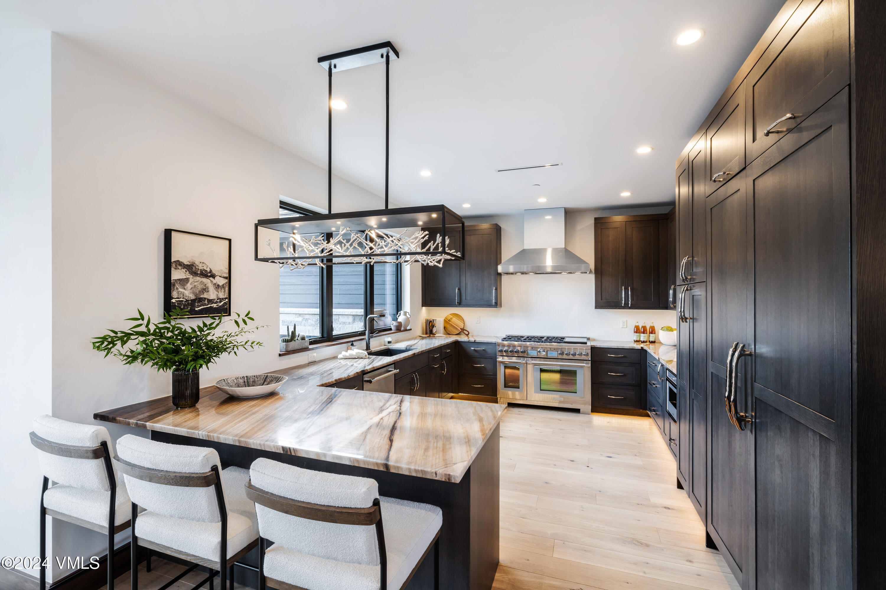 a kitchen with granite countertop a sink stainless steel appliances and white cabinets