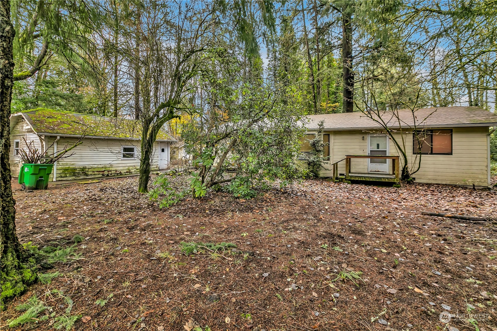 a view of a house with a yard and hanging chair