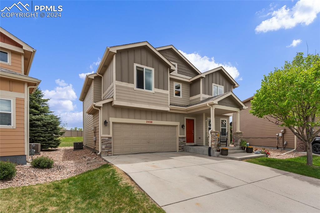 a front view of a house with a yard and garage