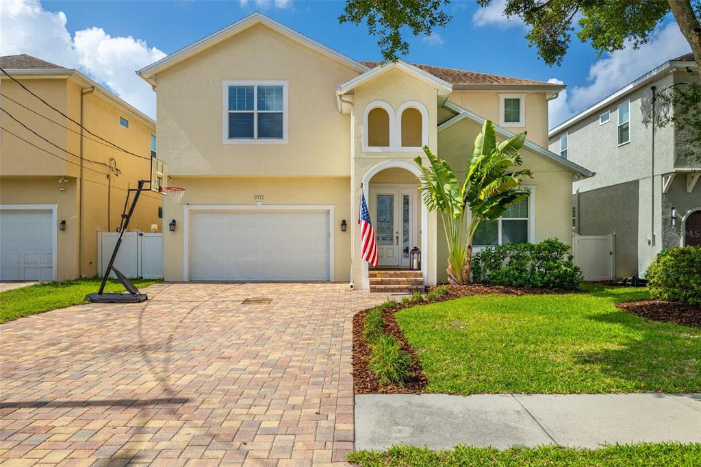 a front view of a house with a yard and garage