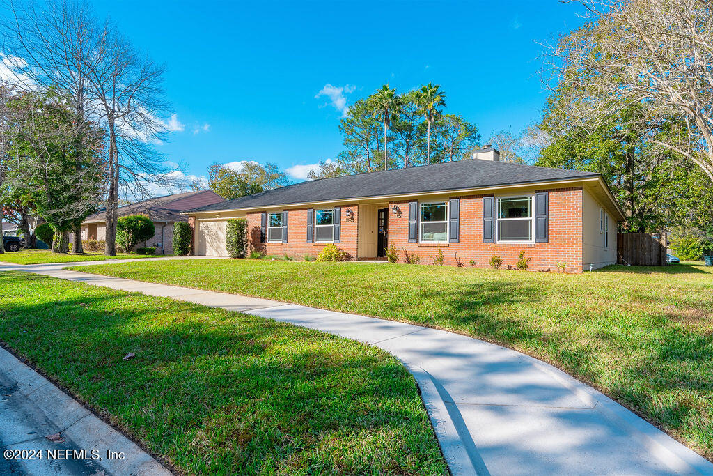 a front view of house with yard and green space