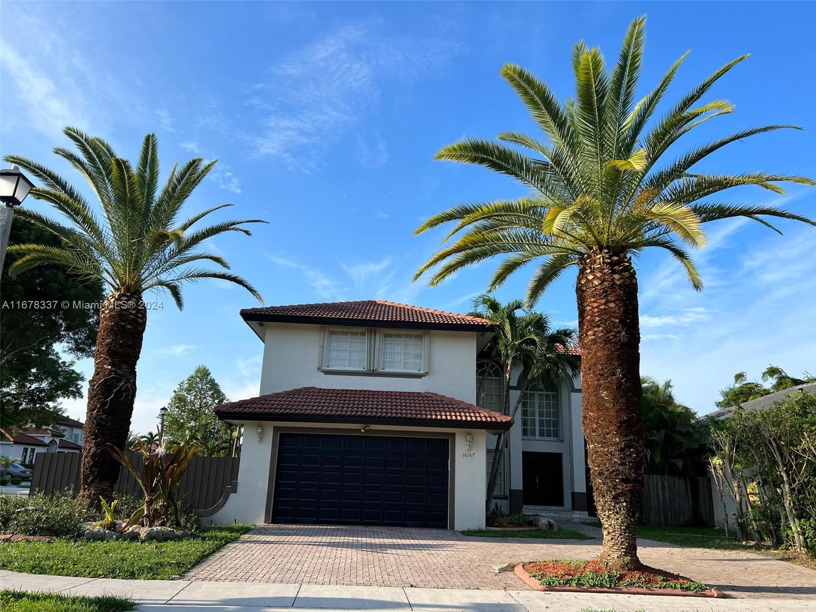 a view of a house with a palm tree