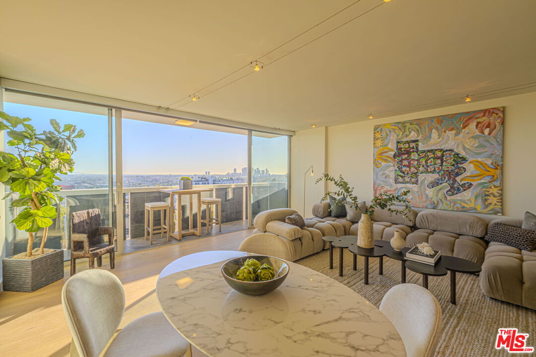 a living room with furniture and a floor to ceiling window