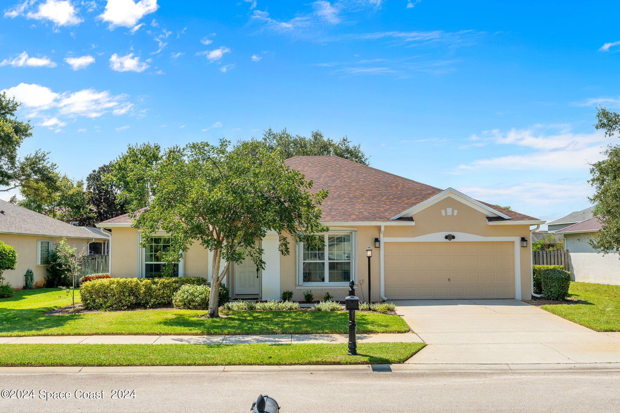 a front view of a house with a yard and garage