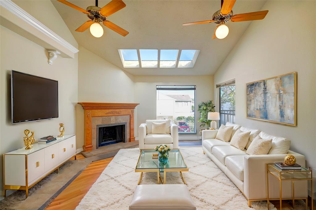 a living room with furniture flat screen tv and a fireplace