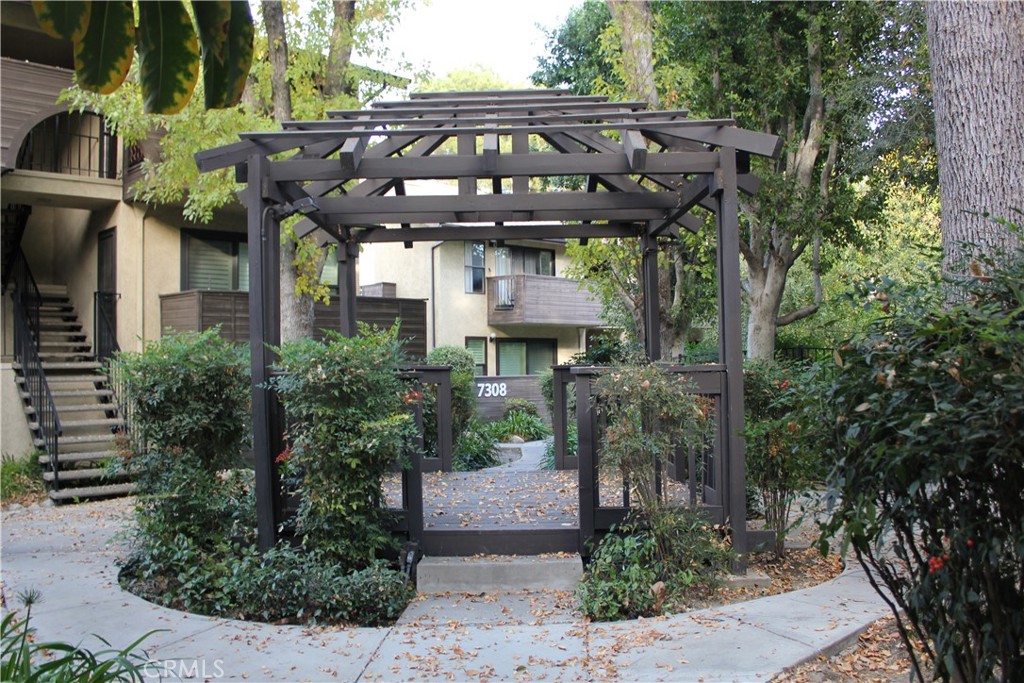 a front view of a house with plants