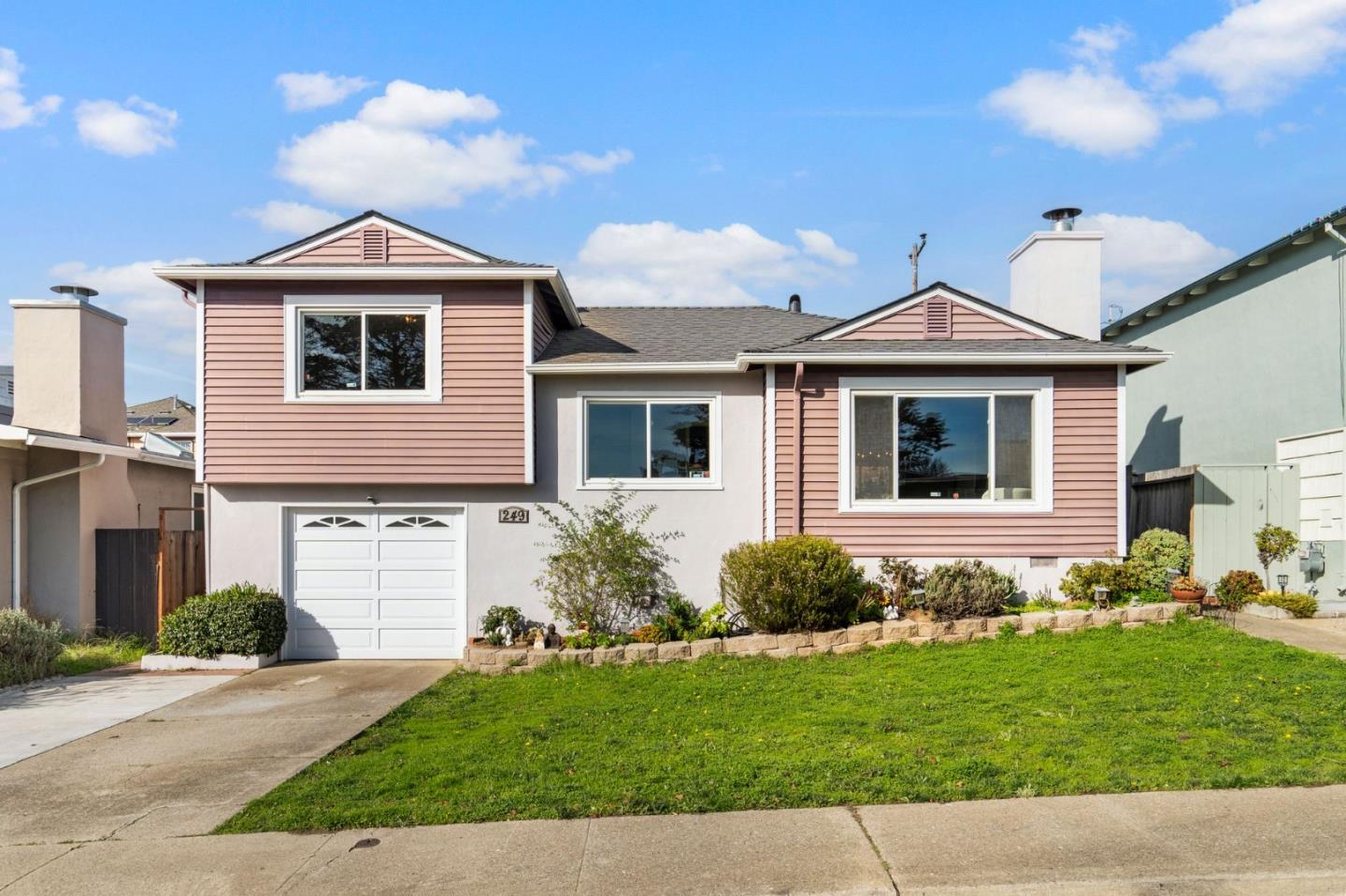 a front view of a house with a yard