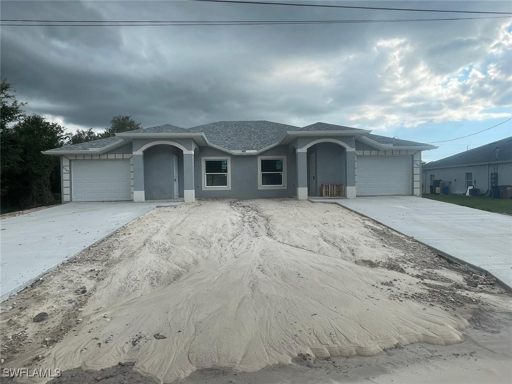 a front view of a house with a yard and garage