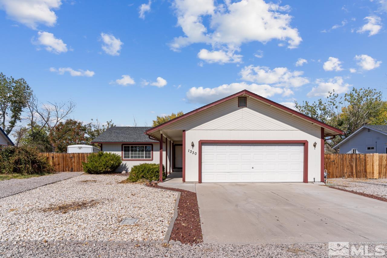 a view of a house with a yard and garage