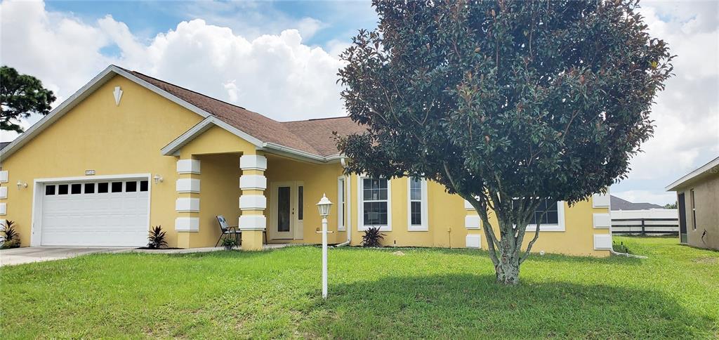 a view of a house with a backyard