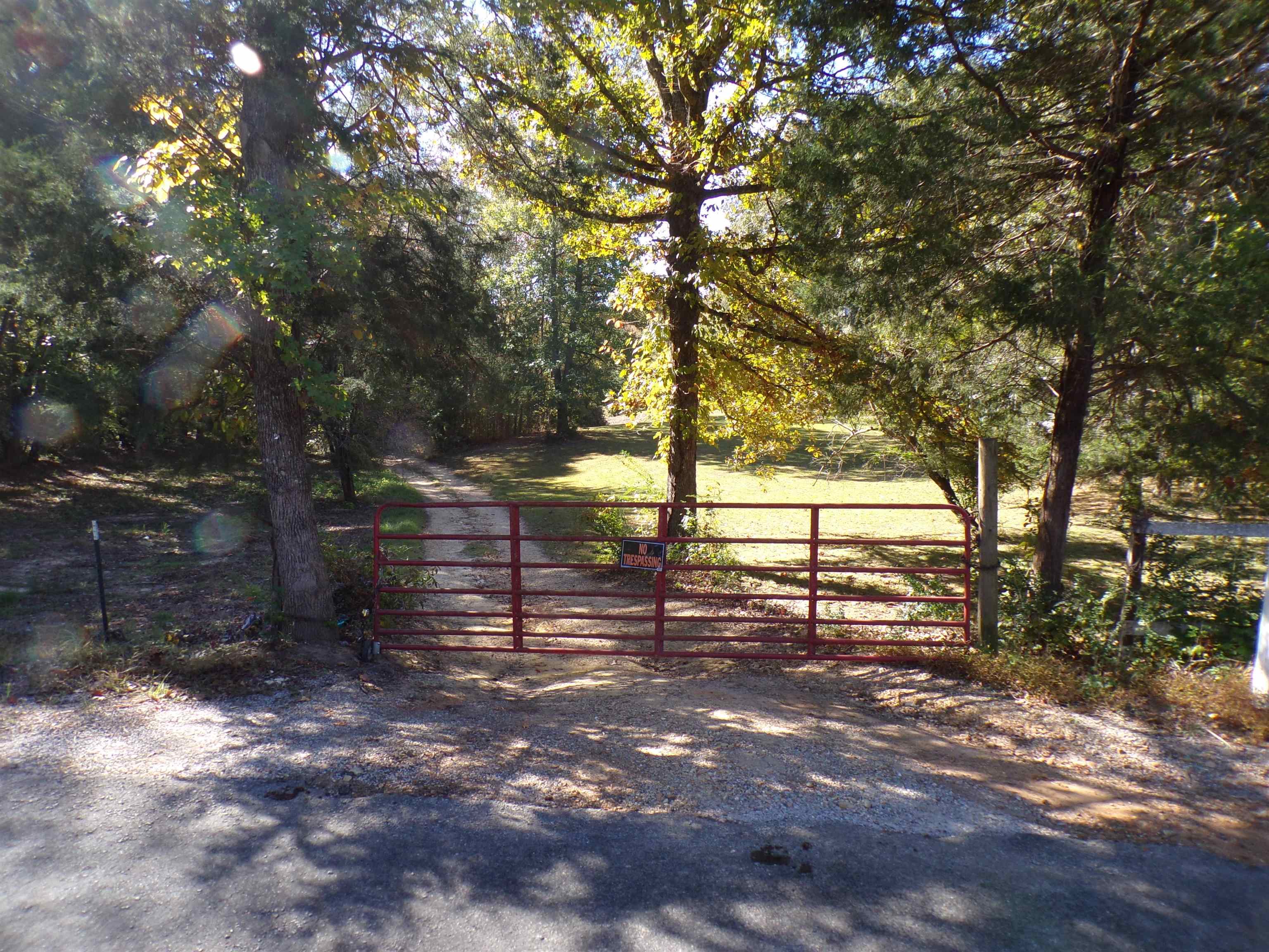 View of gate with a rural view