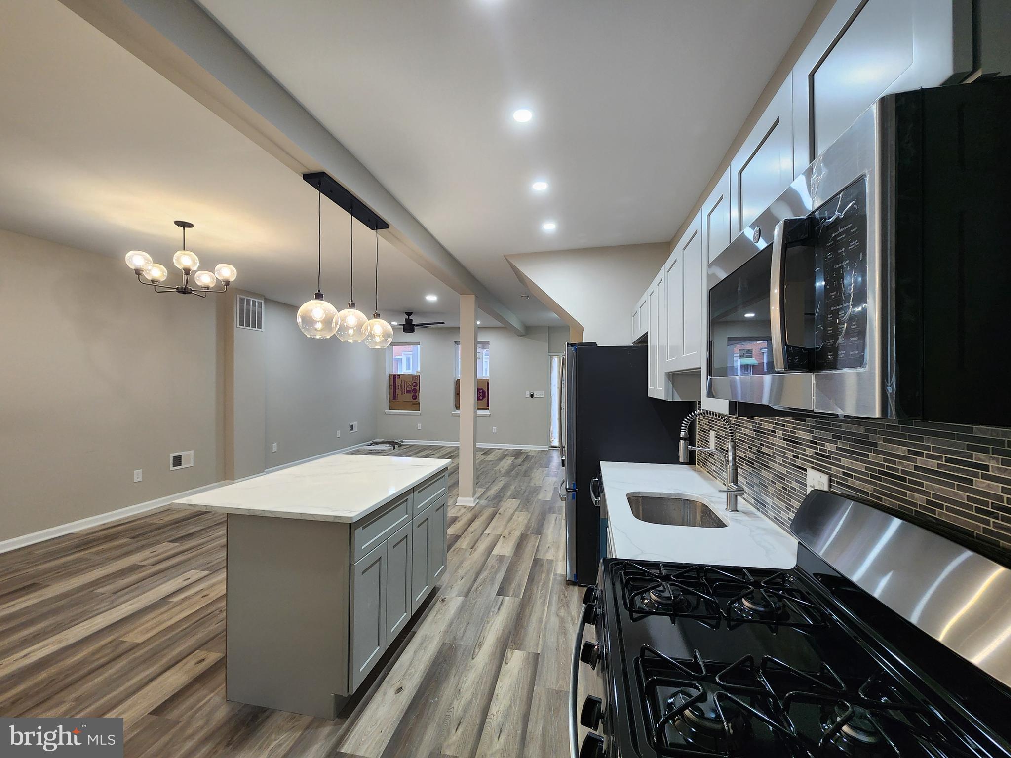 a spacious bathroom with a granite countertop sink a mirror and shower