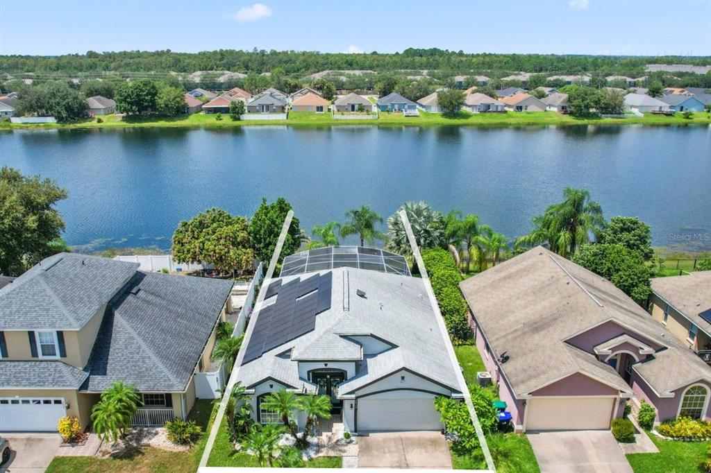 an aerial view of a house with a lake view