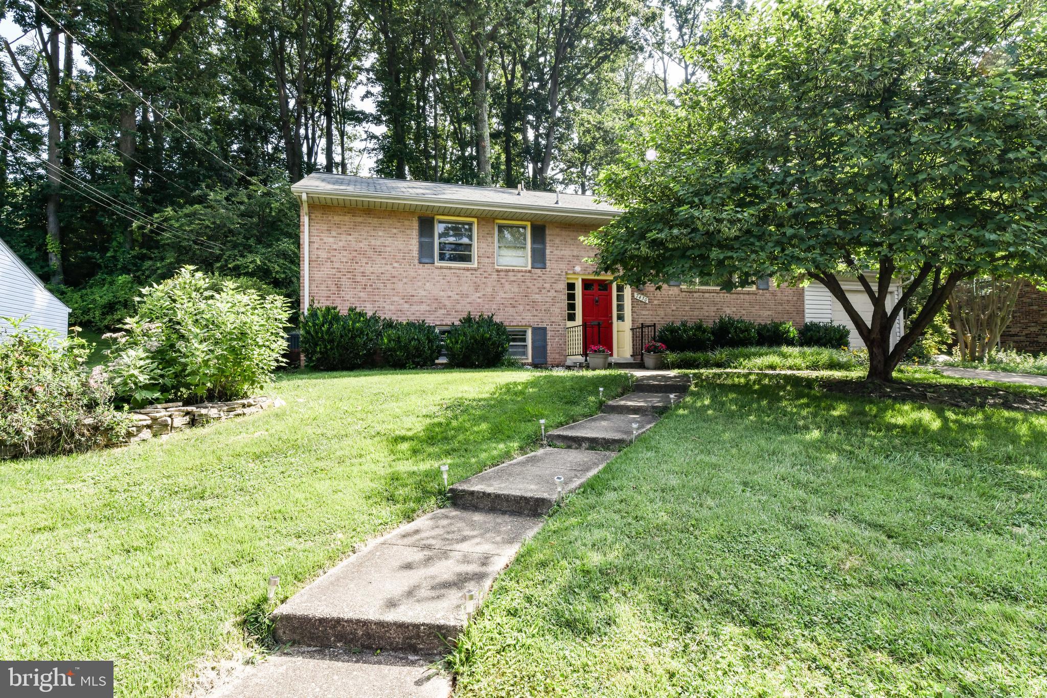 a view of a house with a yard and plants