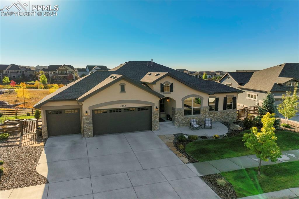 Customized Granby Floor  plan crafted by award wining Goetzamann Custom Homes on a fabulous .29 Acre Executive Lot backing the 16 Acre Wild Rumpus Park featuring Pikes Peak Views, walking trails, pond, play area + more!