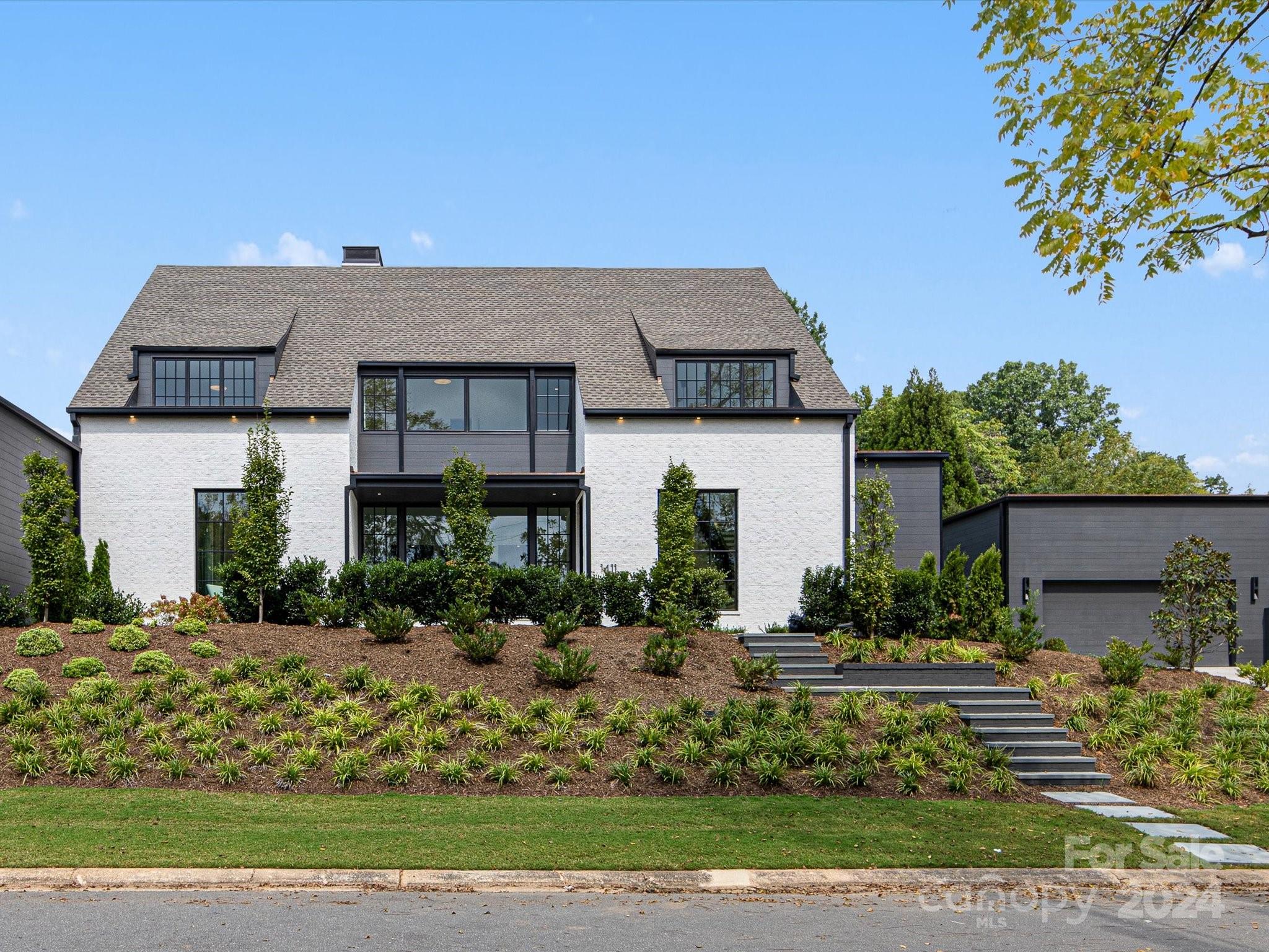 a front view of a house with a garden