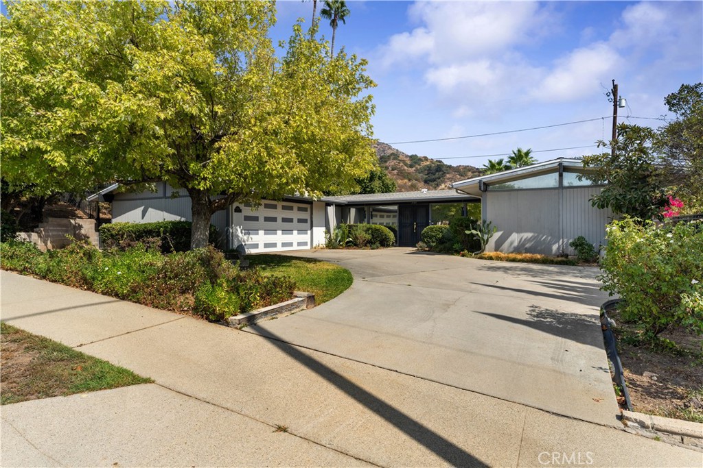 a view of house with yard and green space