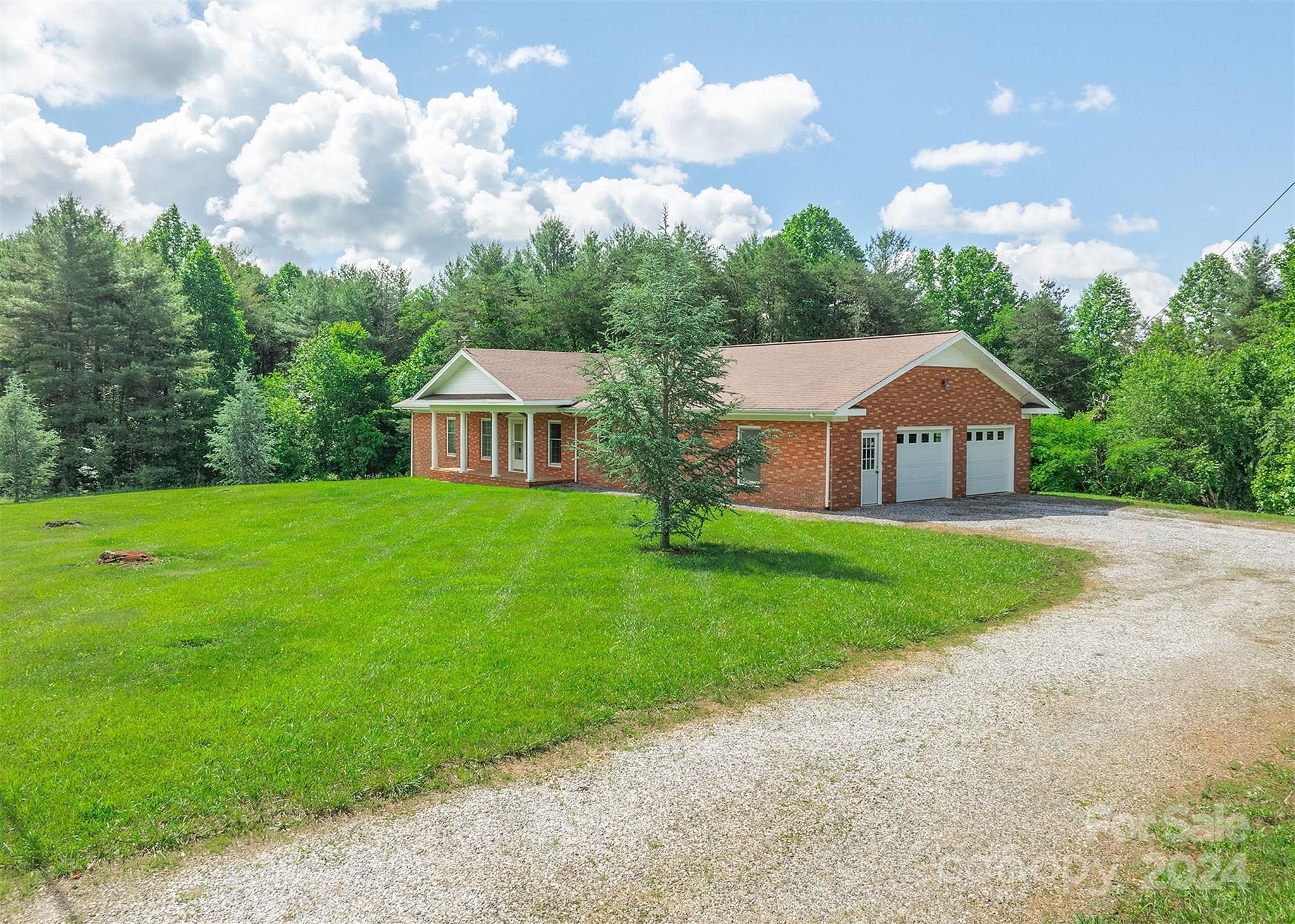 a front view of house with yard and green space