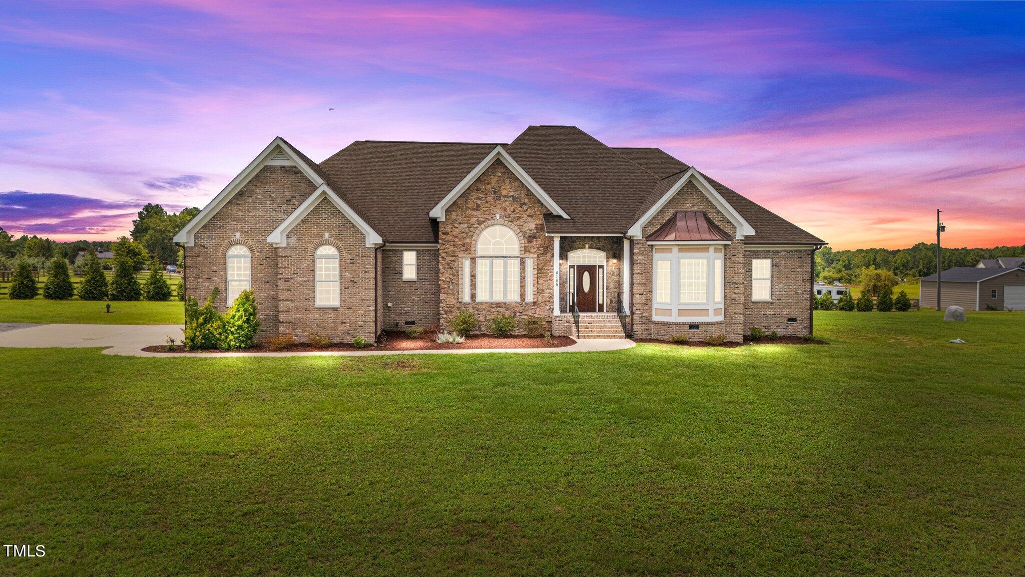 a front view of a house with a yard