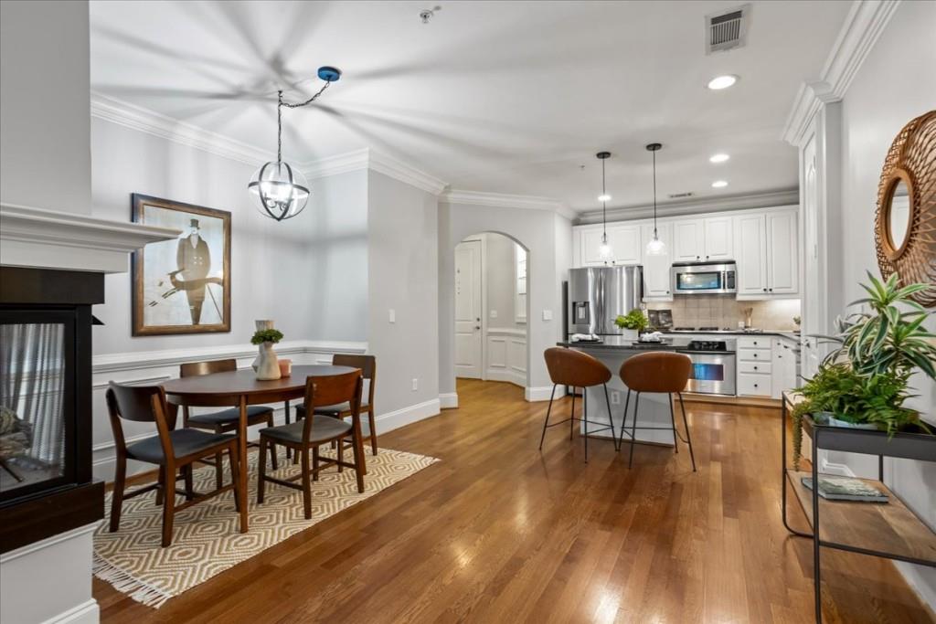 a view of a dining room with furniture window and wooden floor