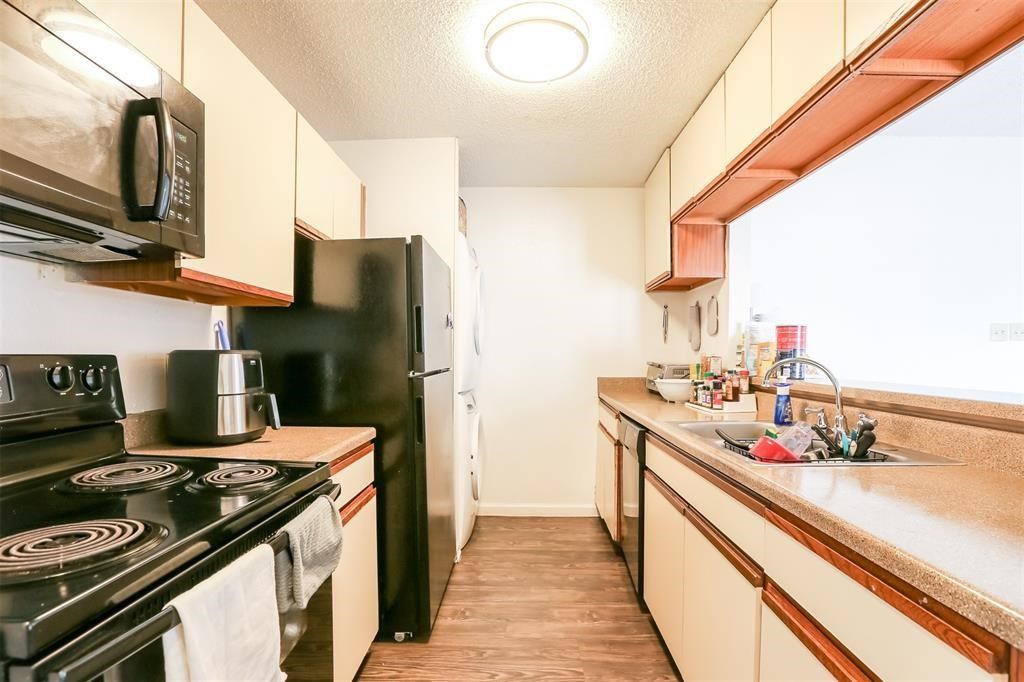 a kitchen with a stove and a refrigerator