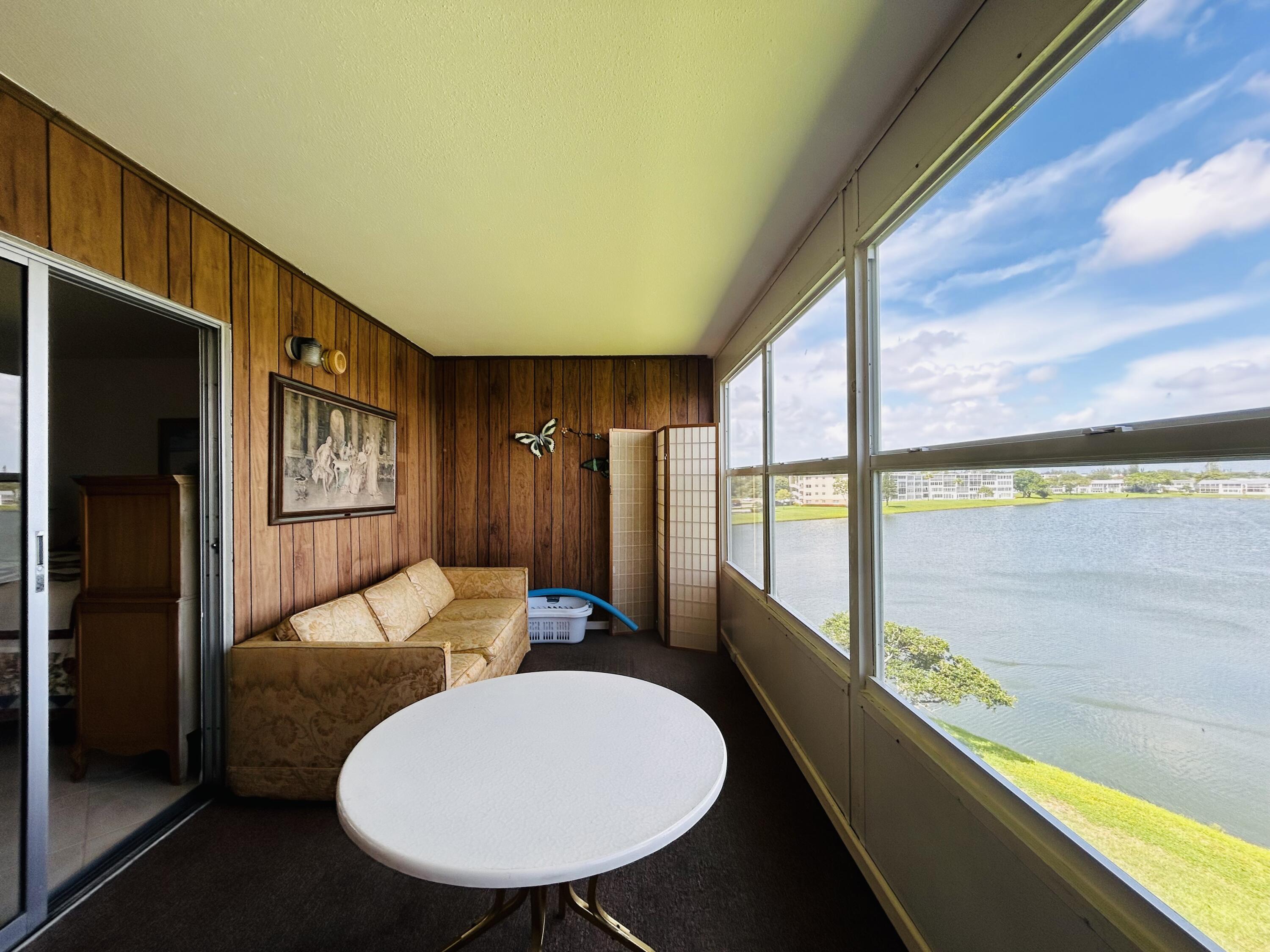 a living room with furniture a window and kitchen view