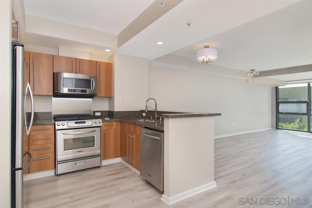 a kitchen with granite countertop a stove and a microwave