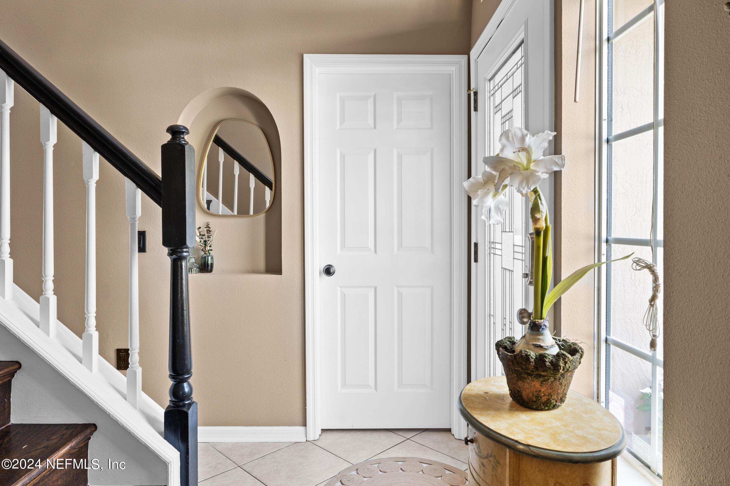 a view of entryway and hall with a potted plant