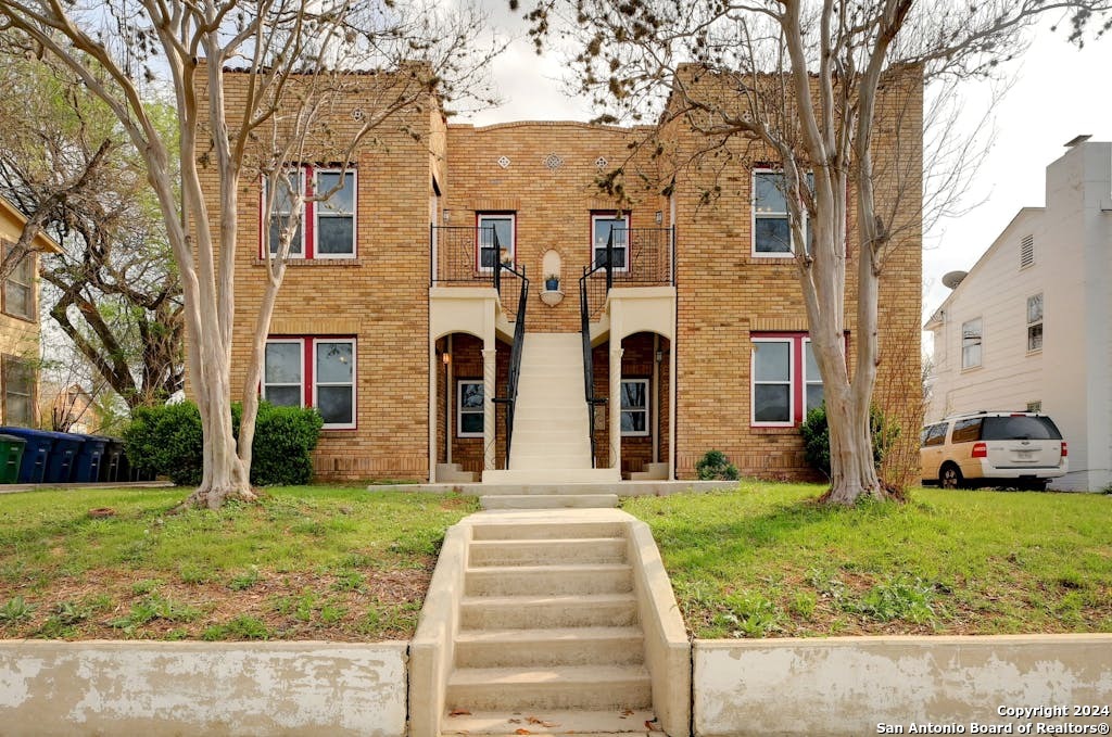 a front view of a house with garden