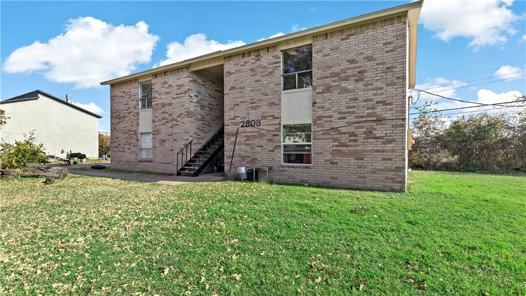 a brick building with a yard