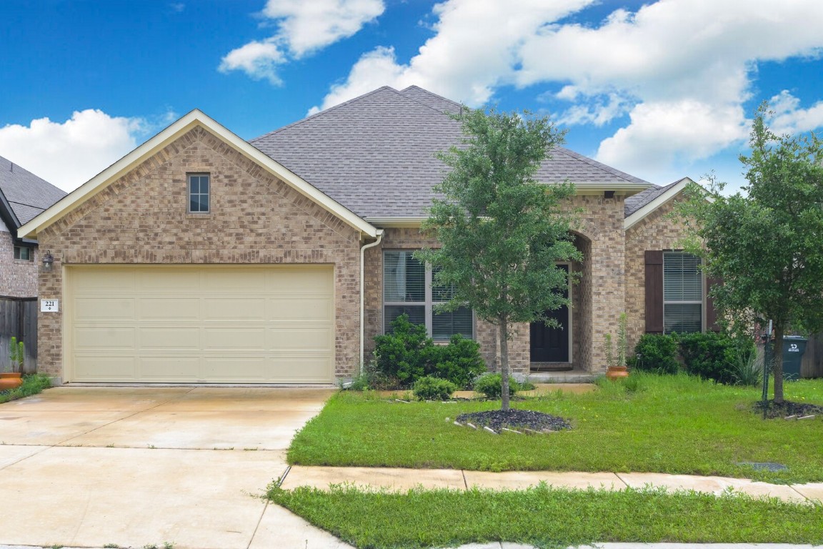 a front view of house with yard and green space