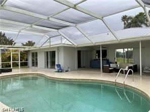 a swimming pool with outdoor seating and yard