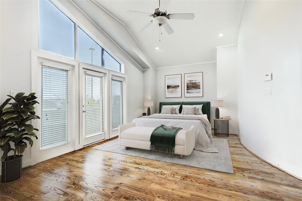 a spacious bedroom with a large bed and a chandelier