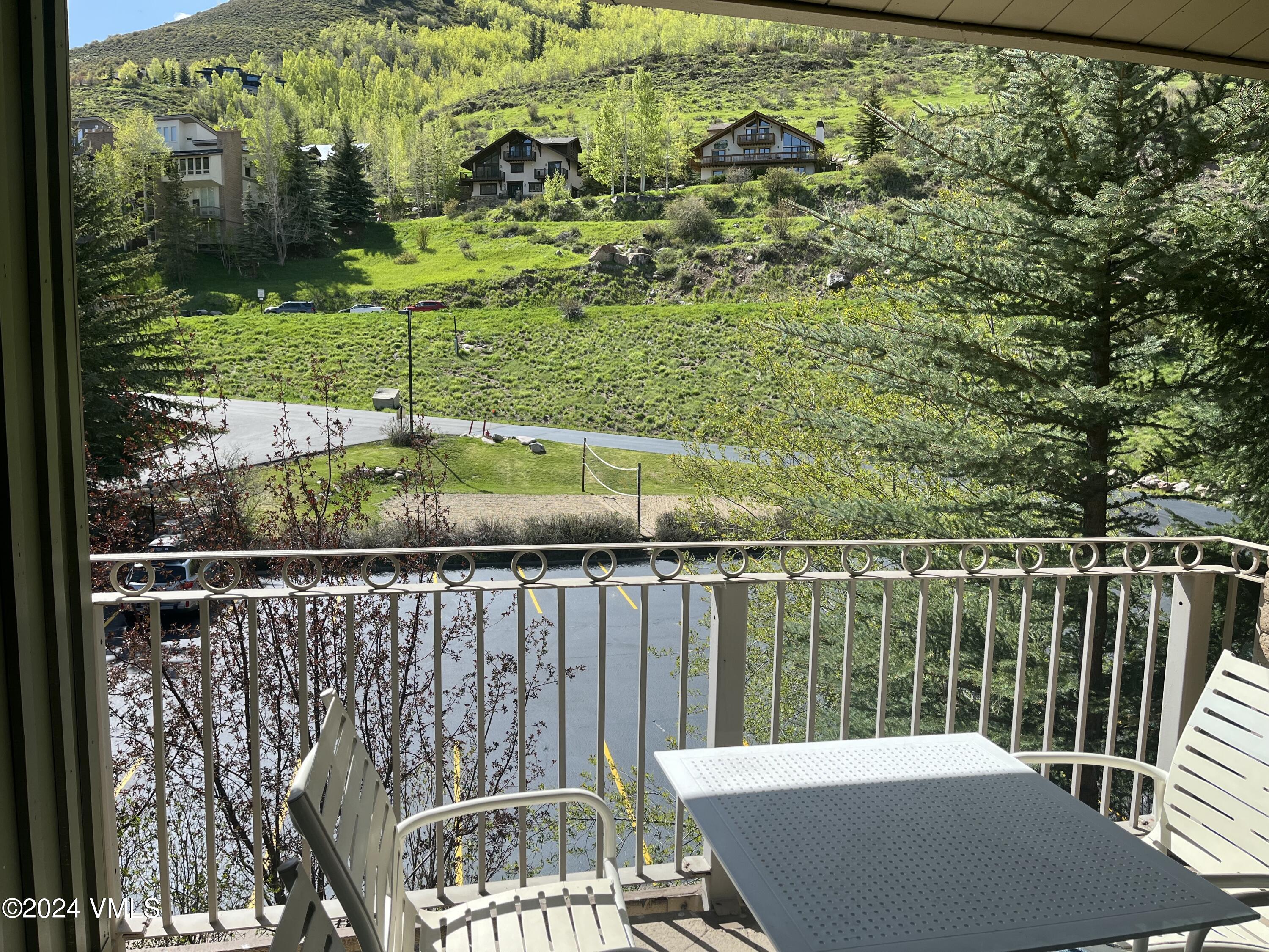 a view of a balcony with yard